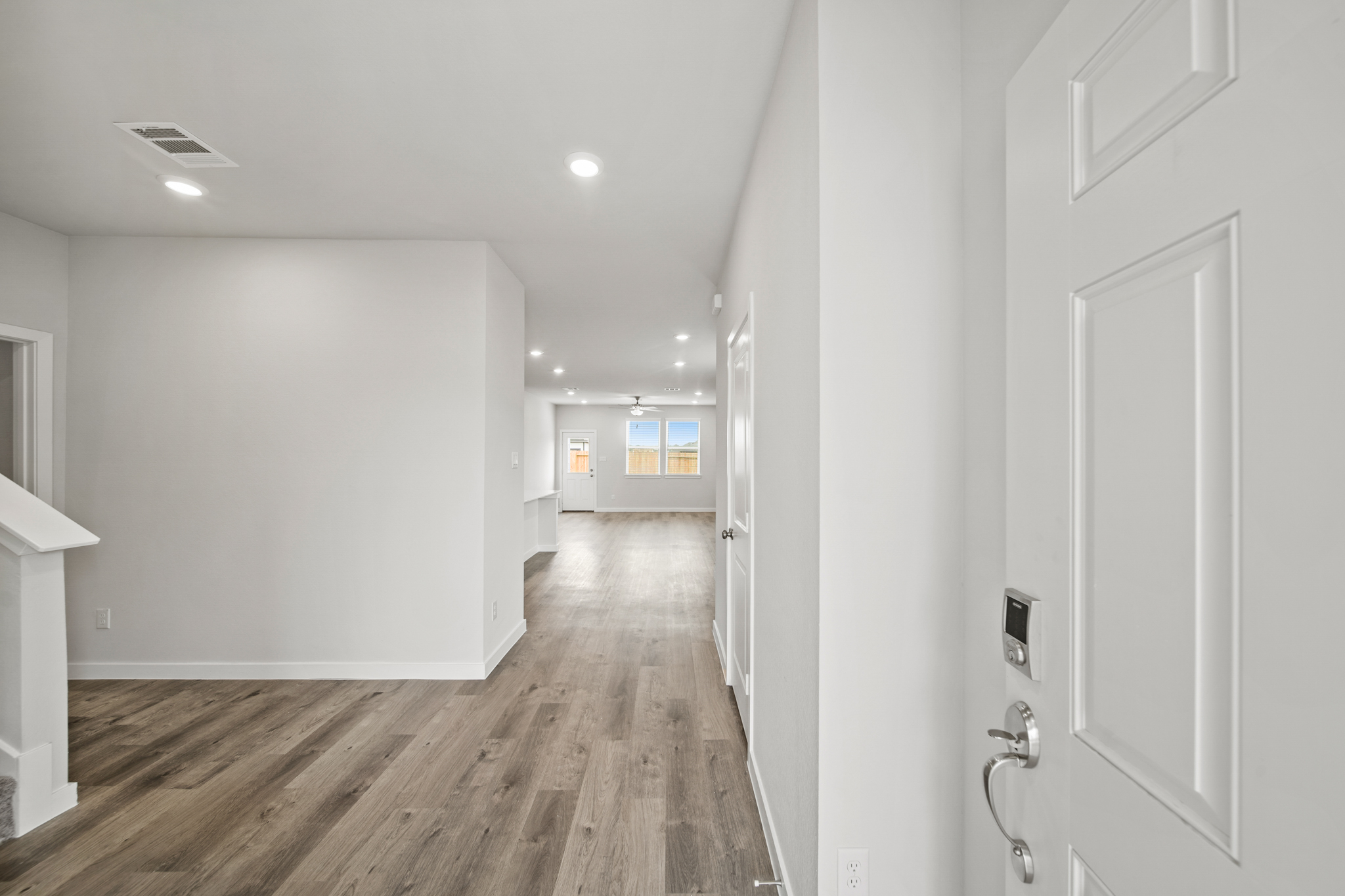 A hallway with white walls.