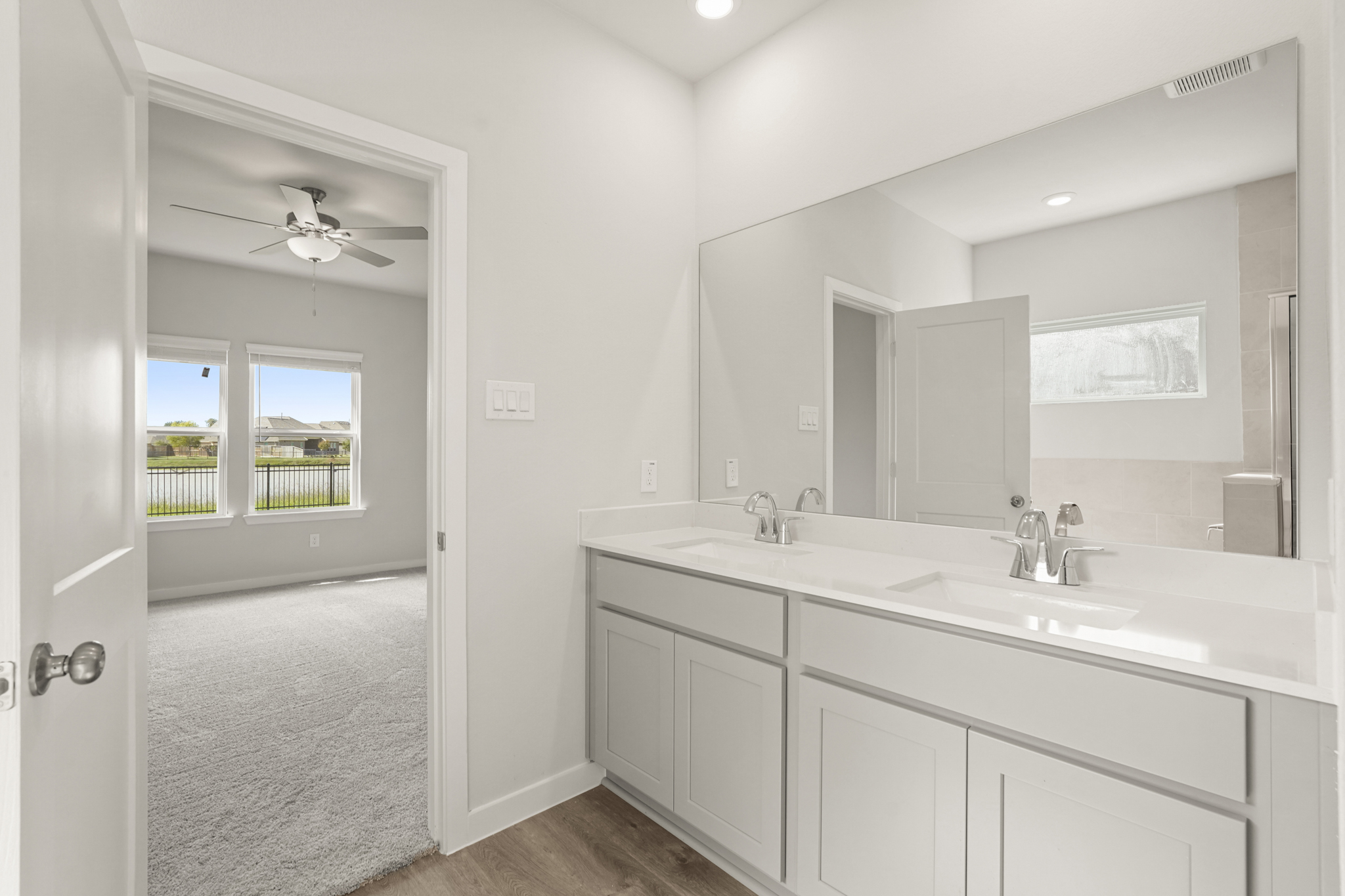 A bathroom with a large mirror.
