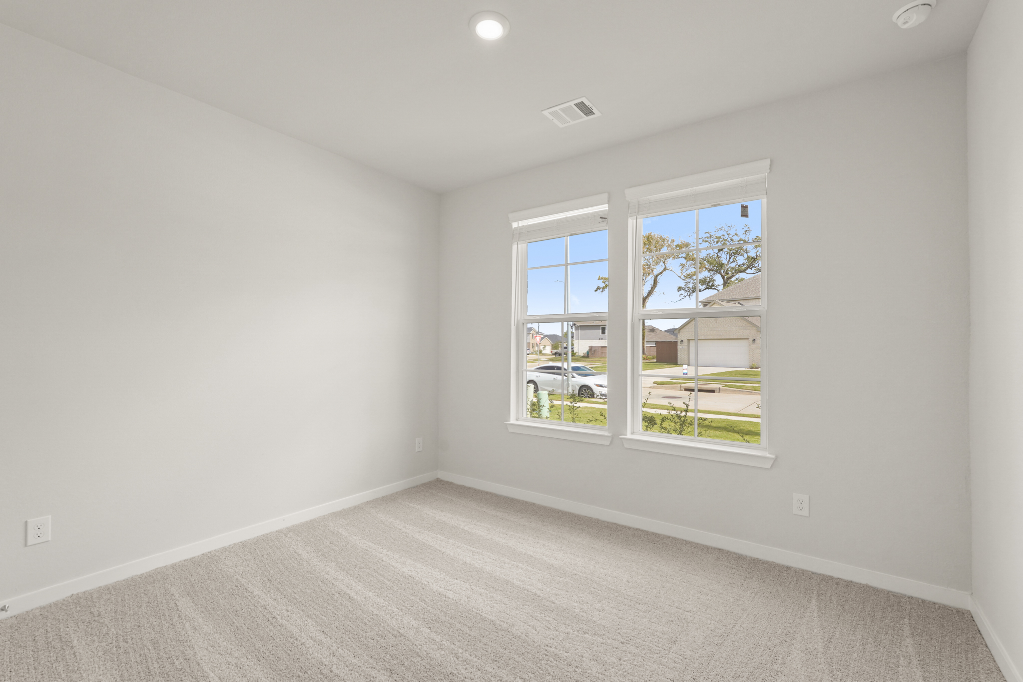 A room with a window and a carpet.