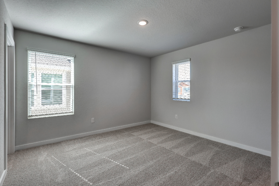 A room with a tile floor and windows.