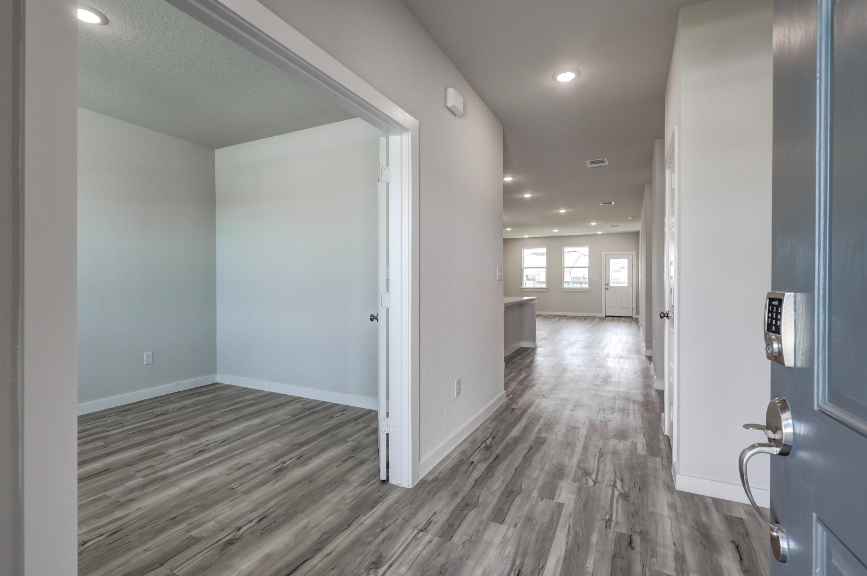A hallway with white doors.