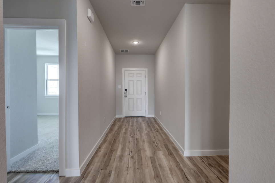 A hallway with white walls.