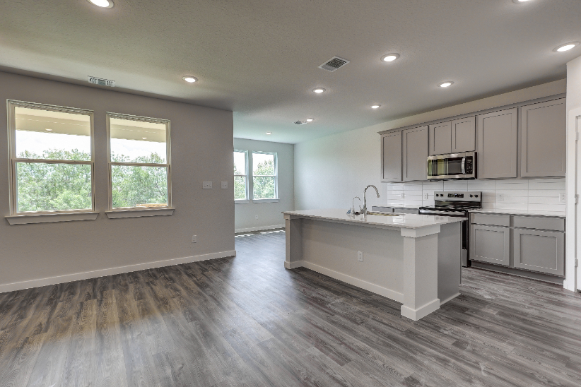 A kitchen with white cabinets.