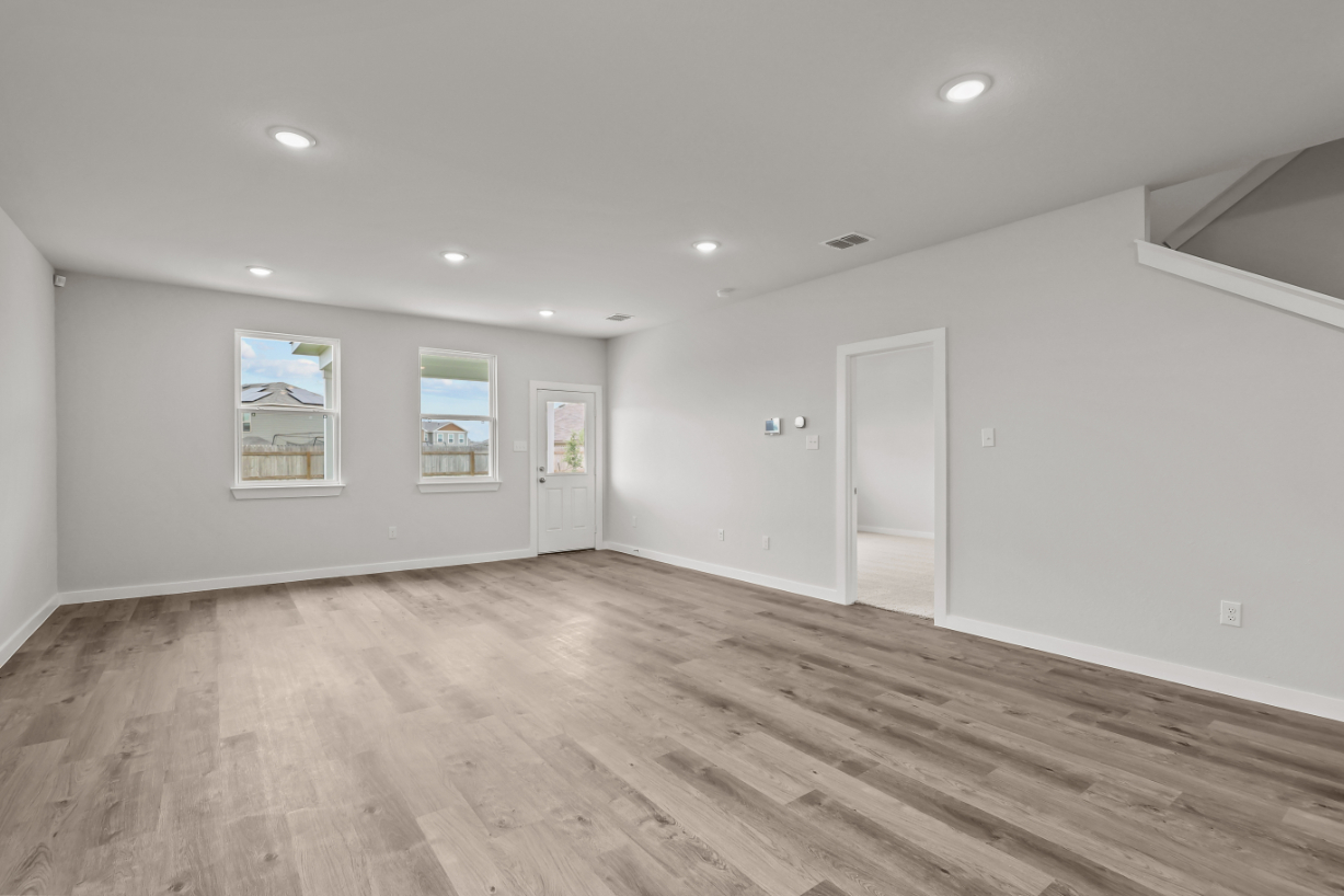 A room with white walls and a wood floor.