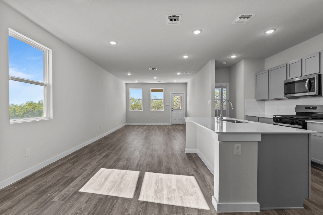 A kitchen with white cabinets.