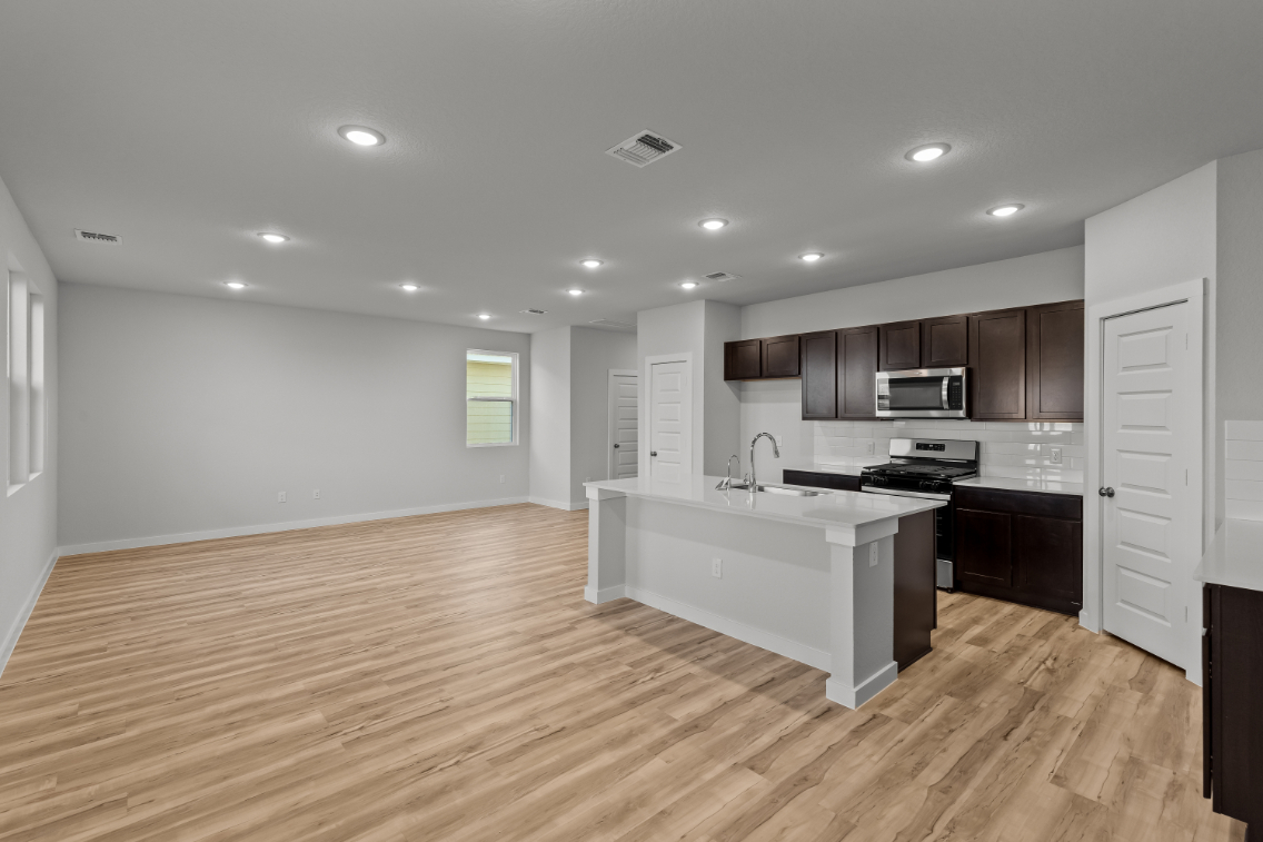 A kitchen with wooden floors.