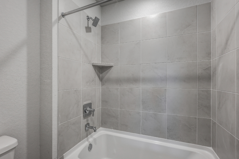 A bathroom with a bathtub and toilet.