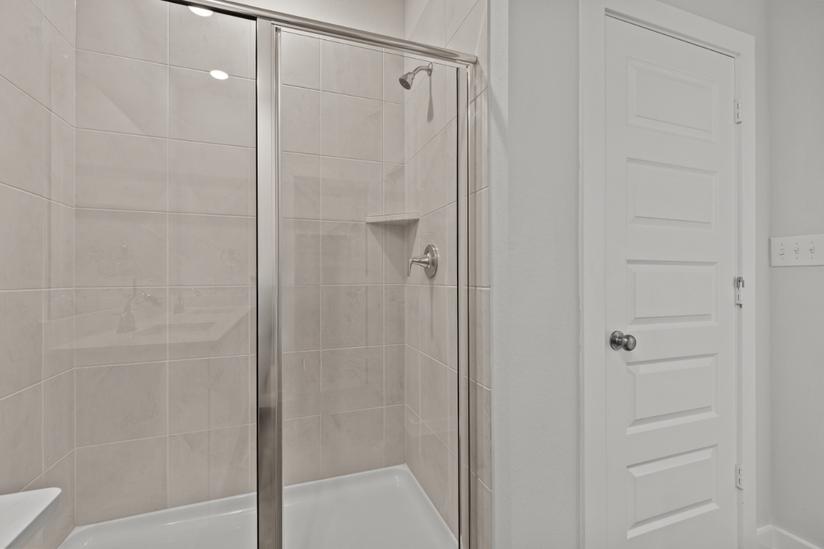 A shower with a glass door.