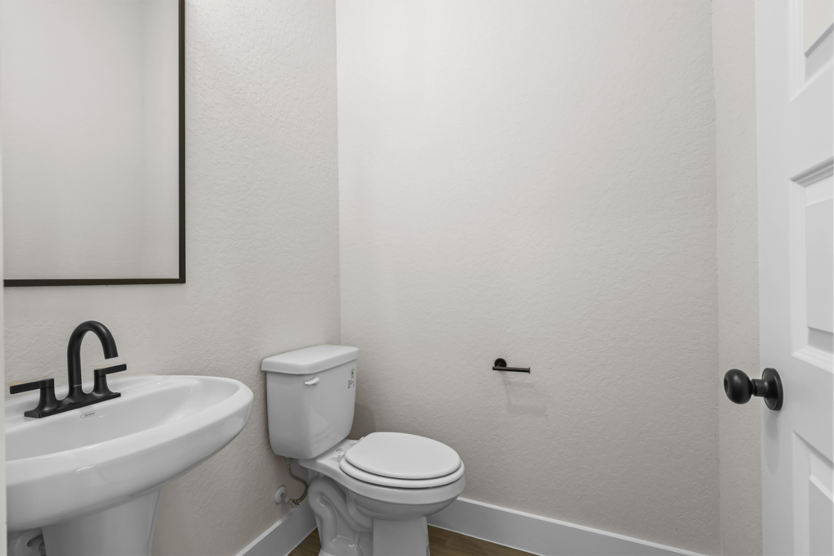A bathroom with a toilet and sink.