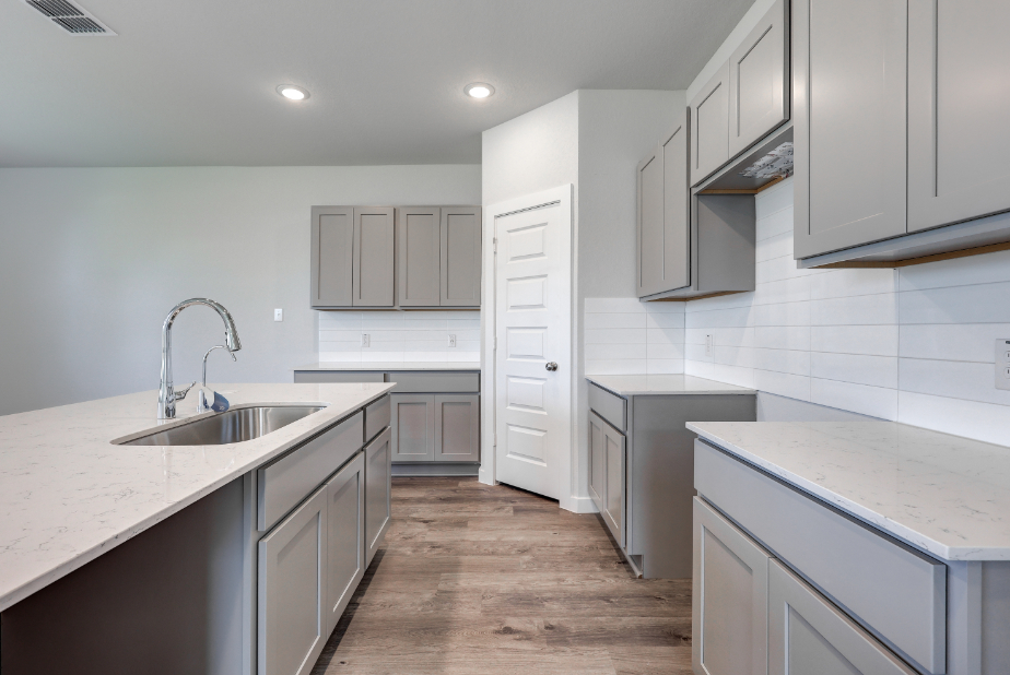A kitchen with white cabinets.
