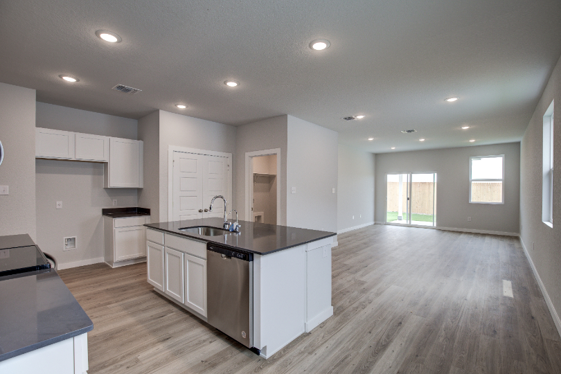 A kitchen with white cabinets.
