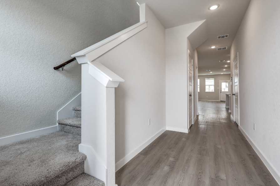 A hallway with white walls.