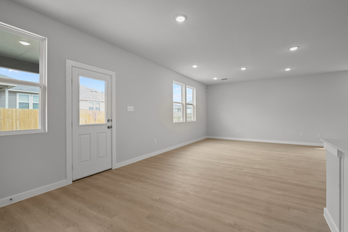 A room with a wood floor and white walls.