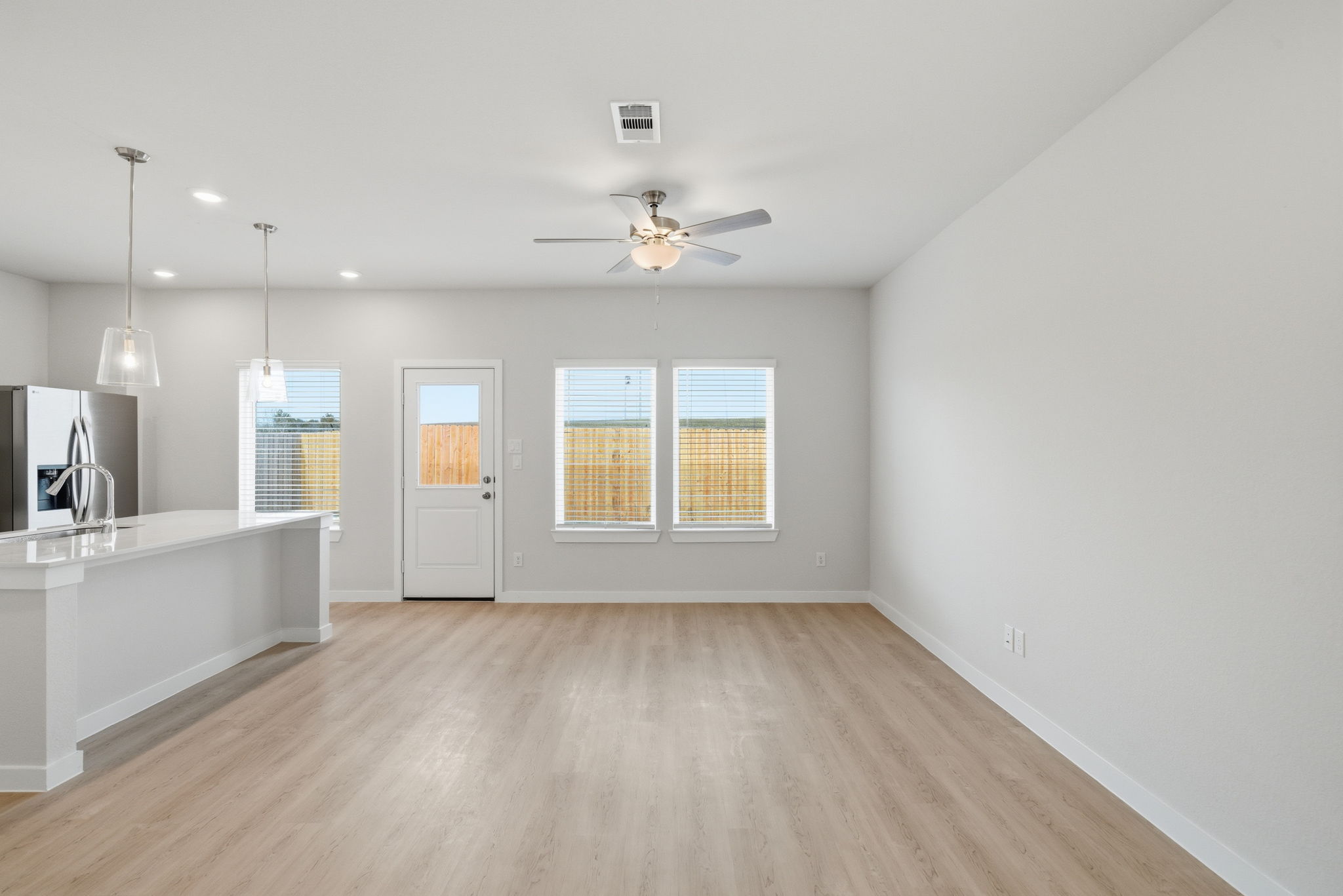A kitchen with a wood floor.