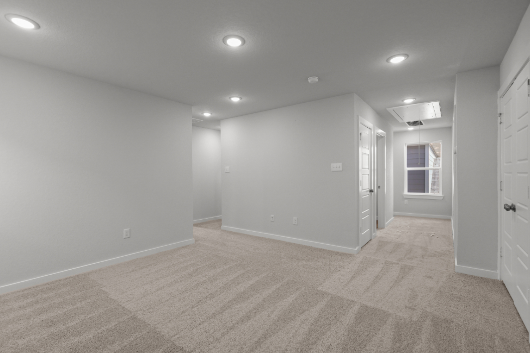 A room with white walls and a wood floor.