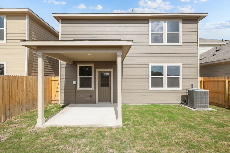 A house with a fence and a yard.