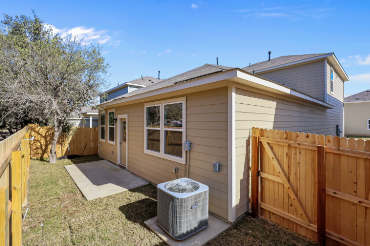 A house with a fence and a wood fence.