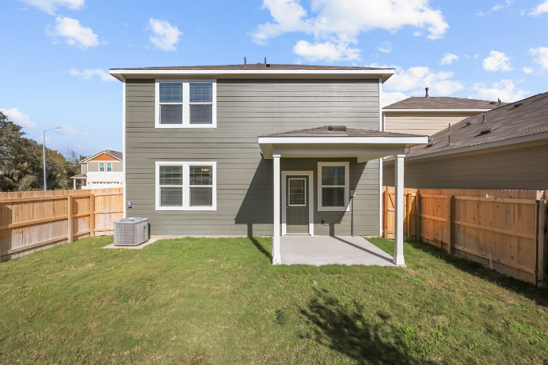 A house with a fence and grass.
