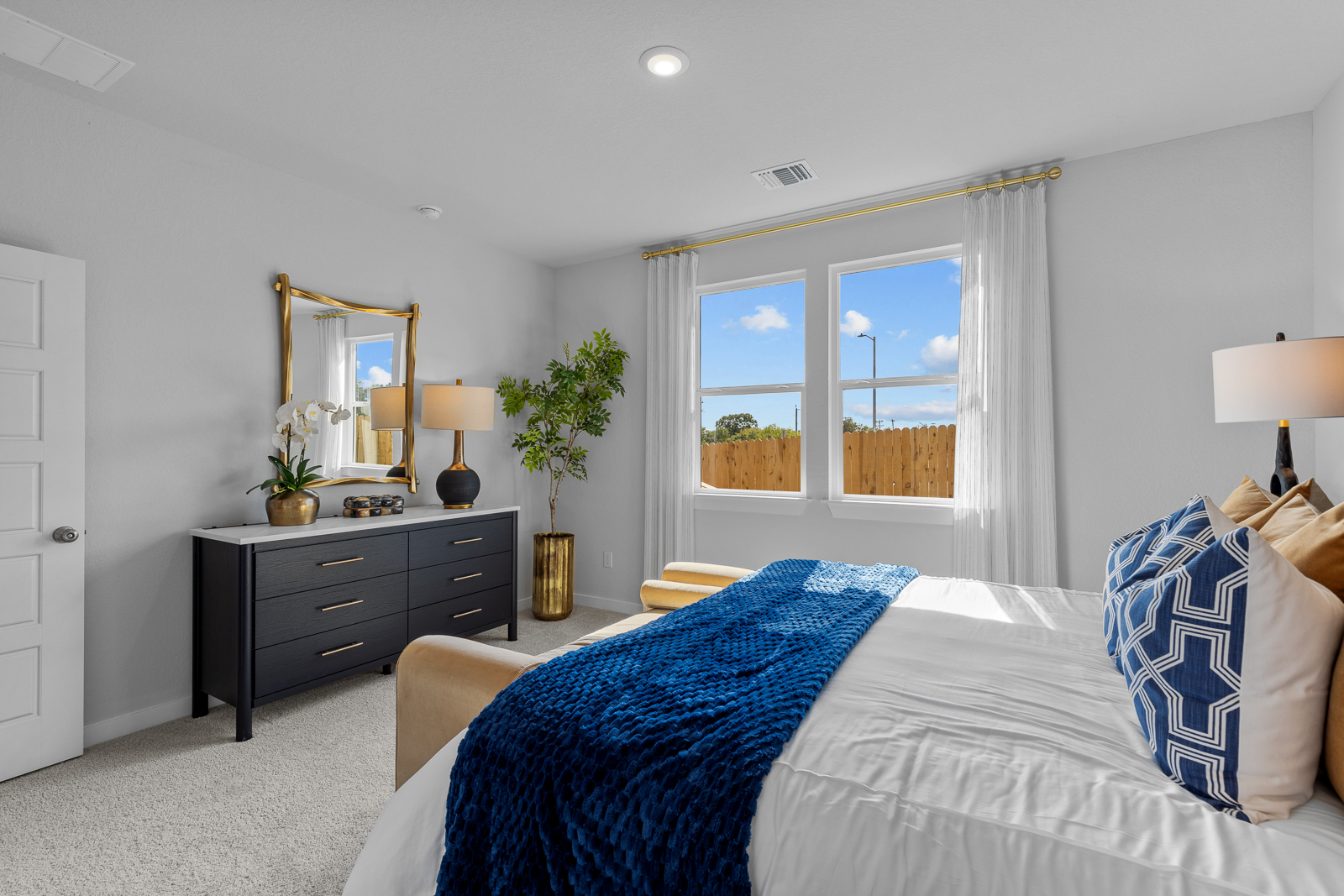 A bedroom with a bed and a window.