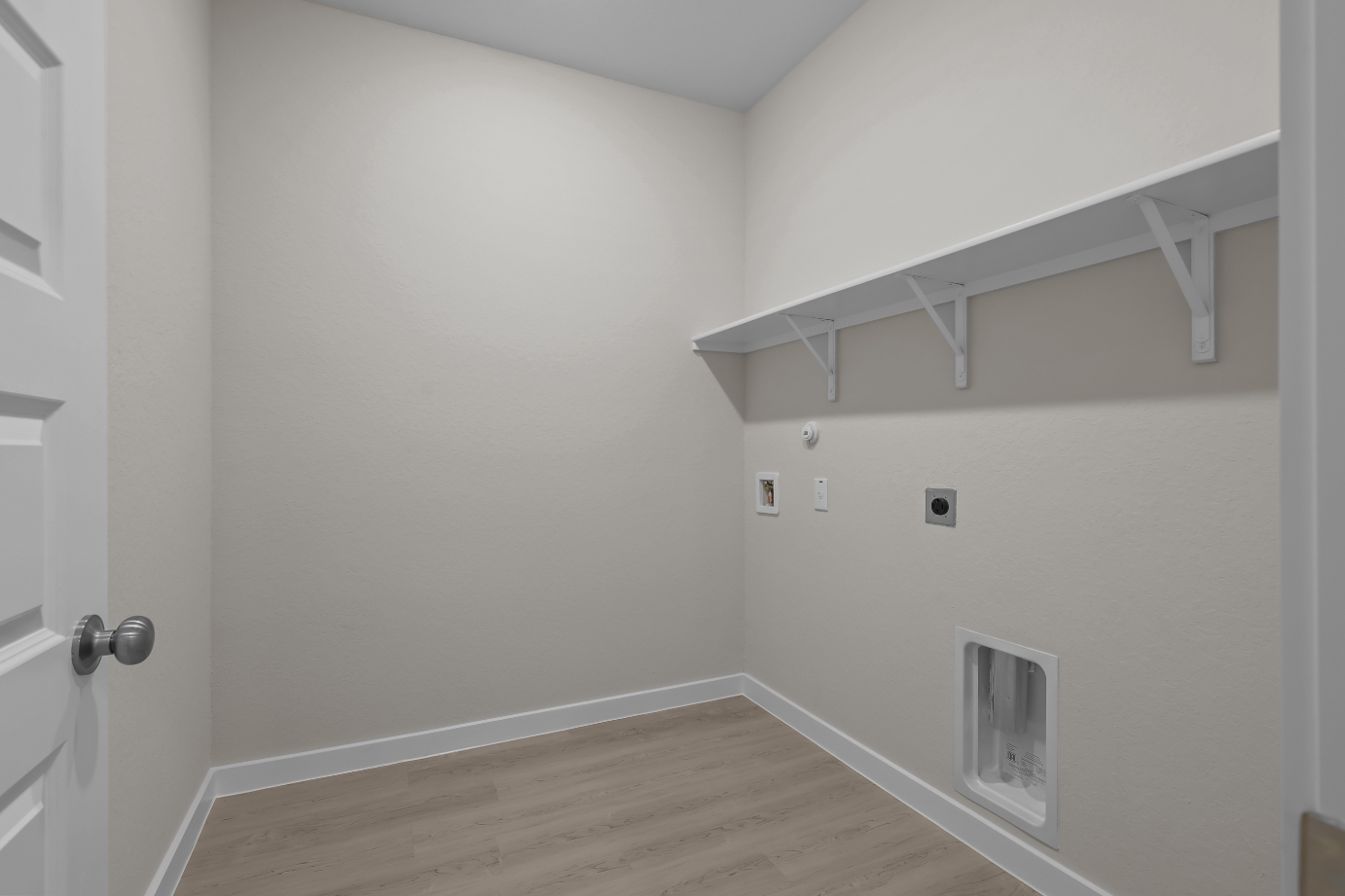 A white room with a wood floor.