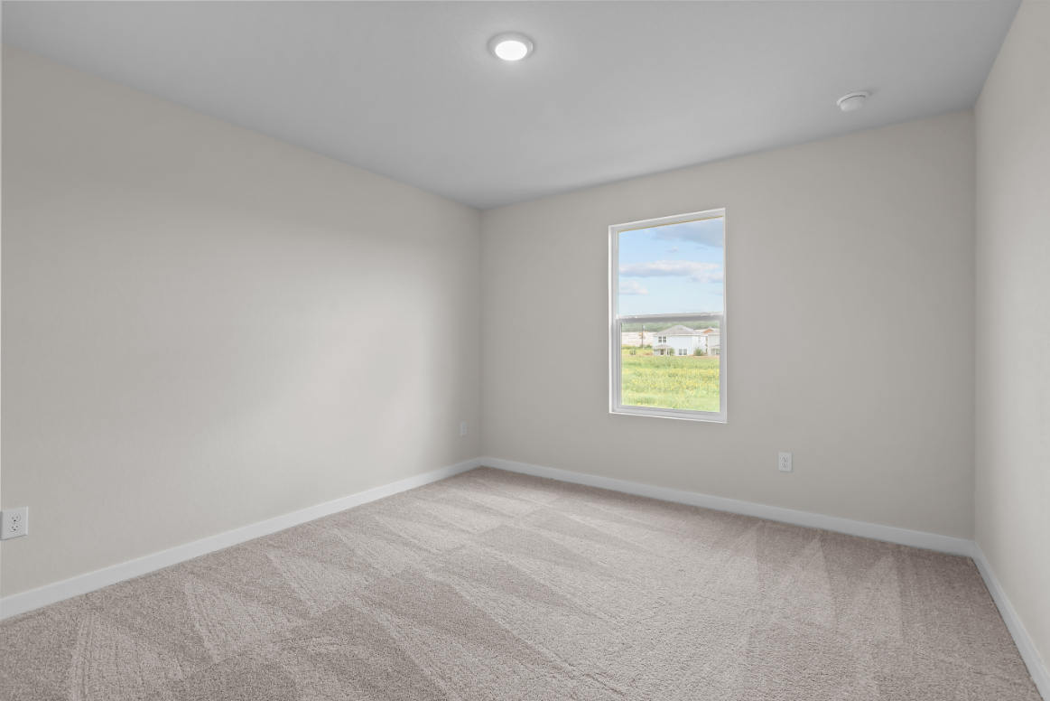 A room with a window and carpet.