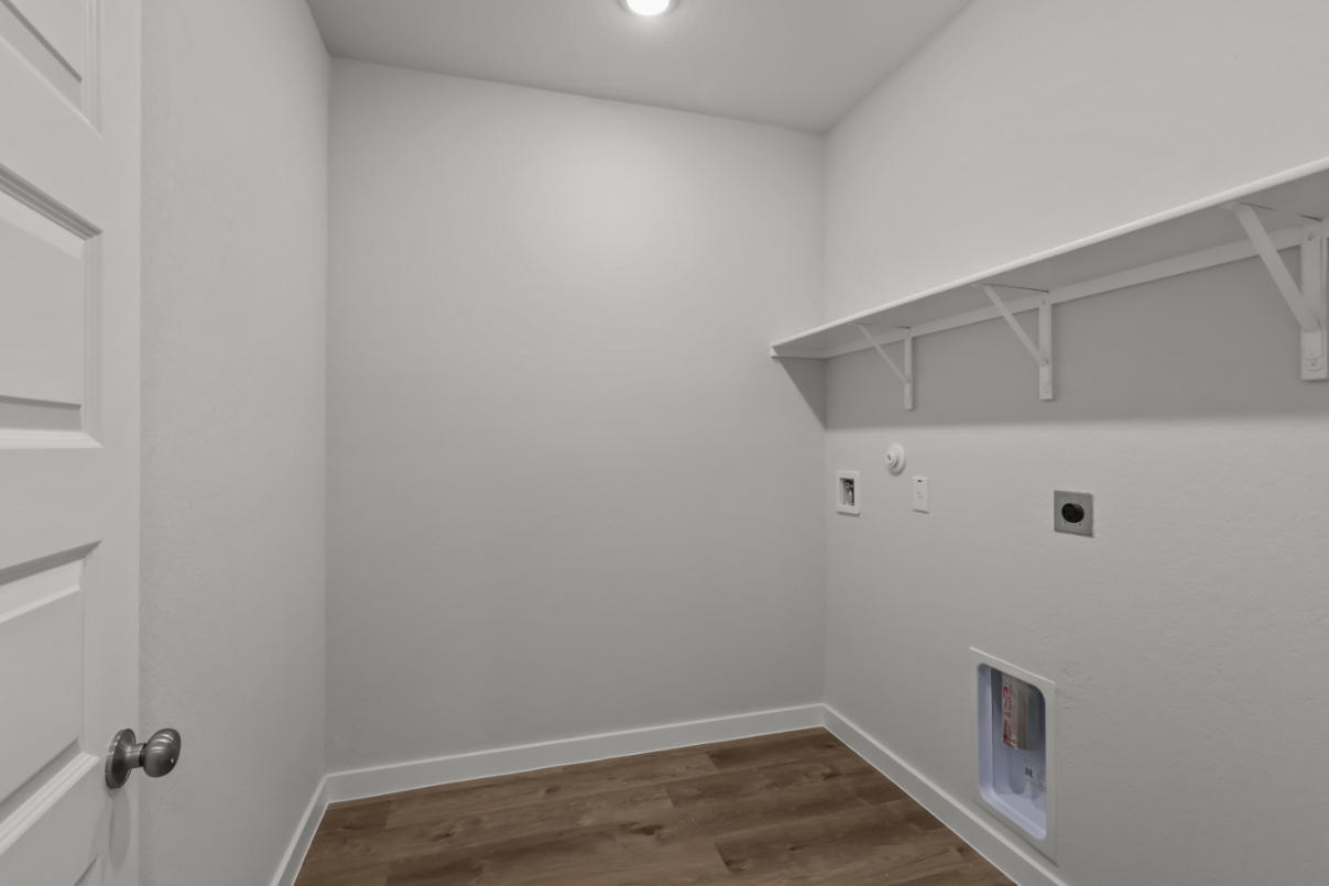 A white room with a wood floor.