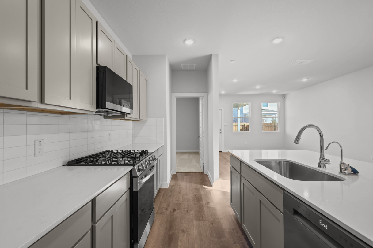 A kitchen with white cabinets.