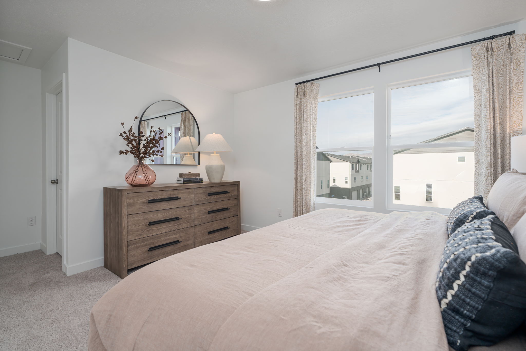 A bedroom with a large window.