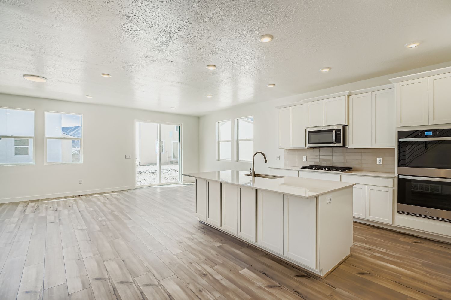 A kitchen with white cabinets.
