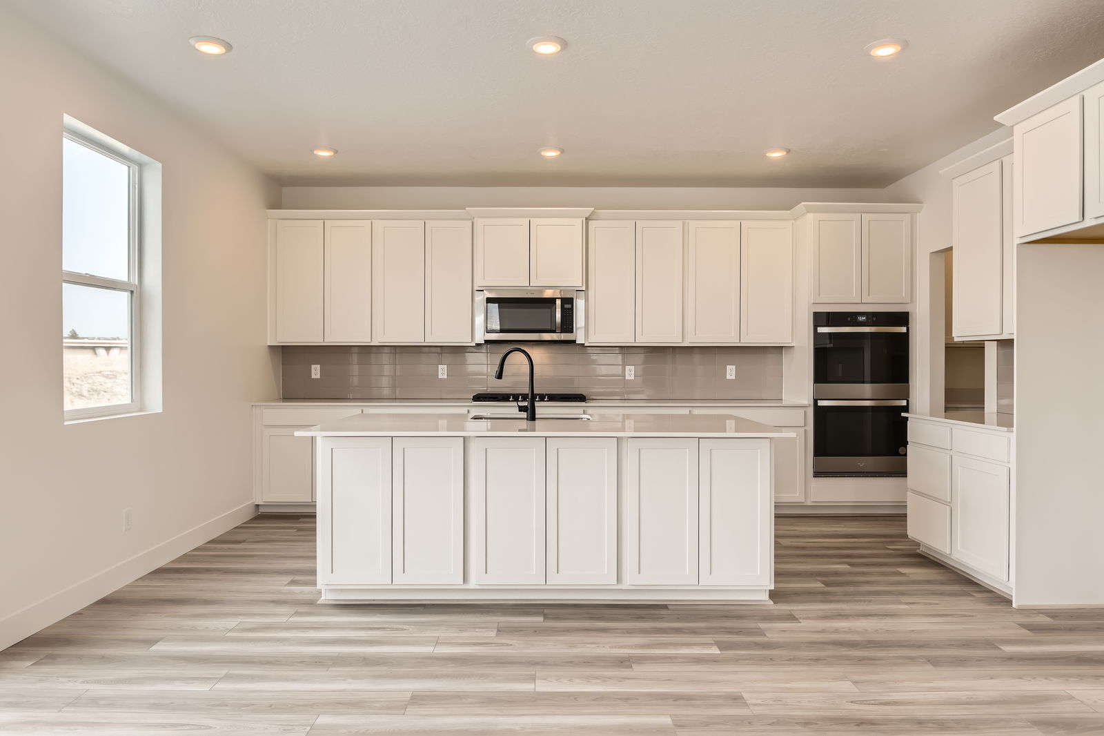 A kitchen with white cabinets.
