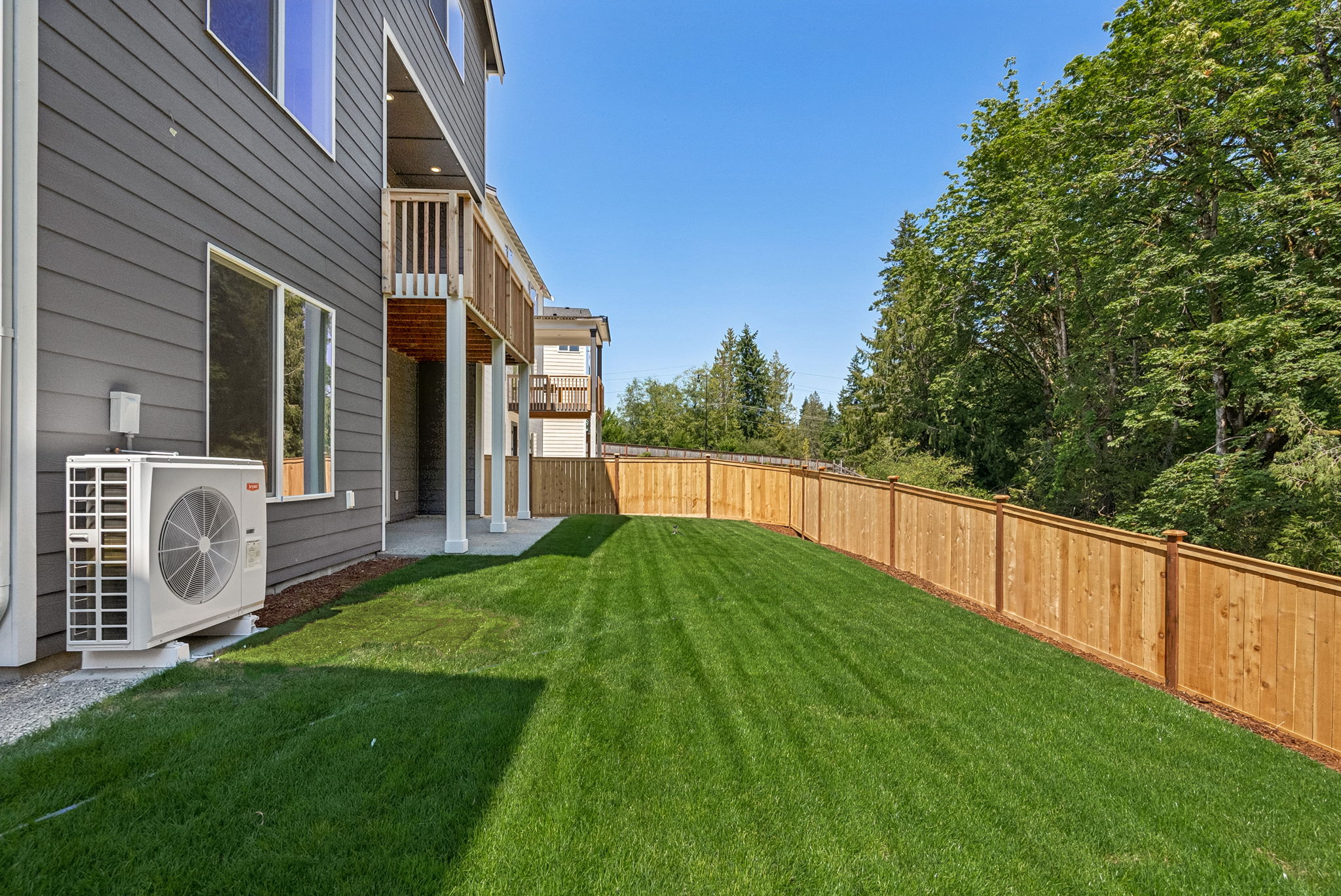 A house with a fence and a lawn.