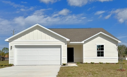 A white house with a garage.