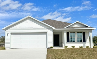 A white house with a garage.