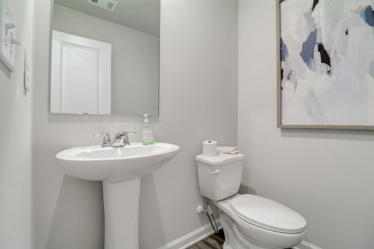 A bathroom with a toilet and sink.