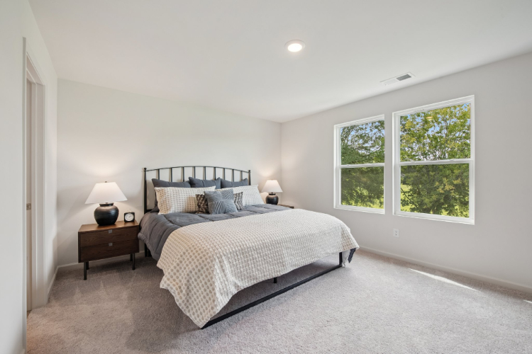 A bedroom with a bed and a window.