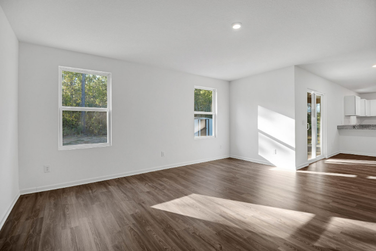A room with a wood floor and windows.