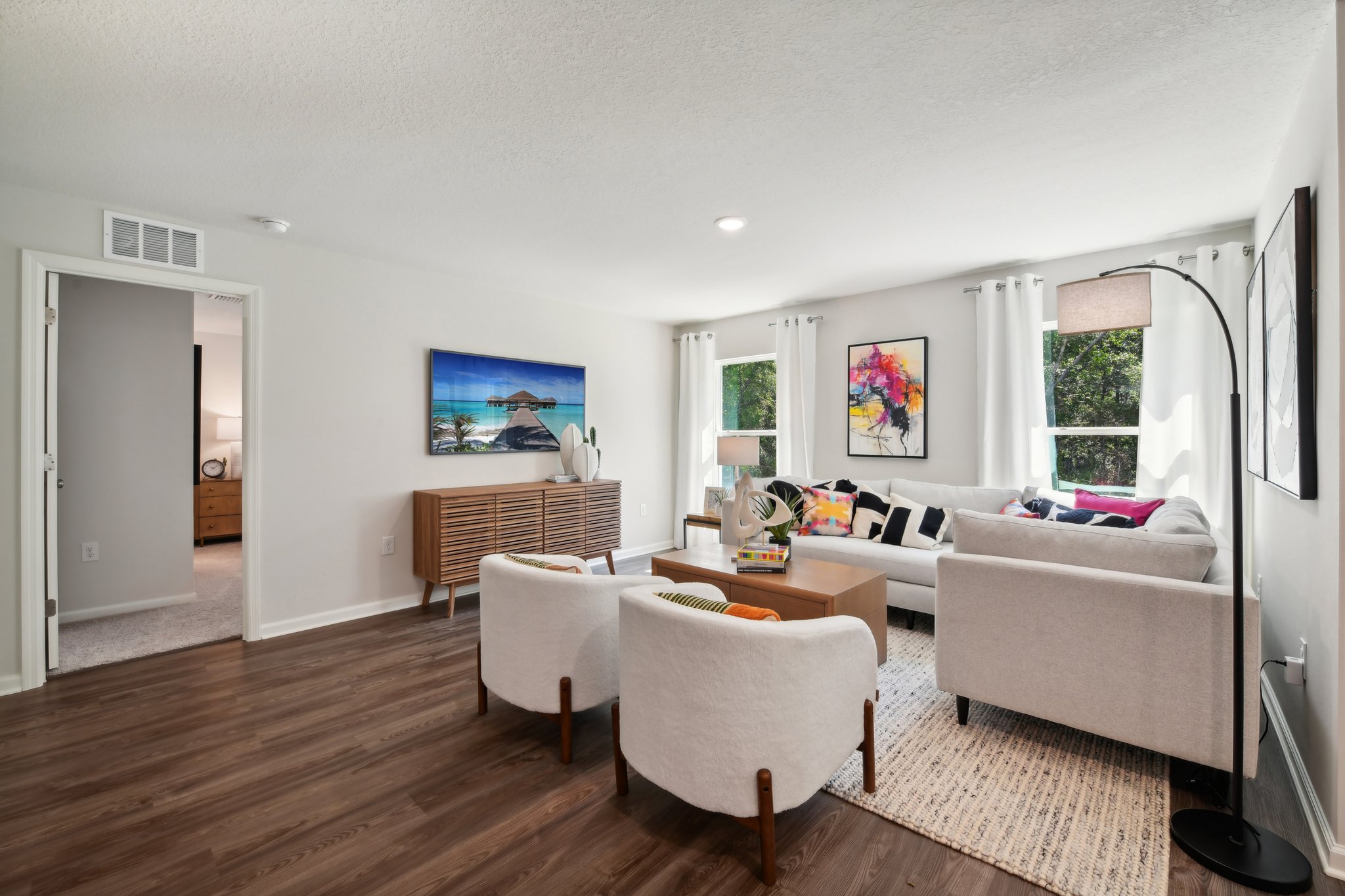 A living room with a couch and chairs.