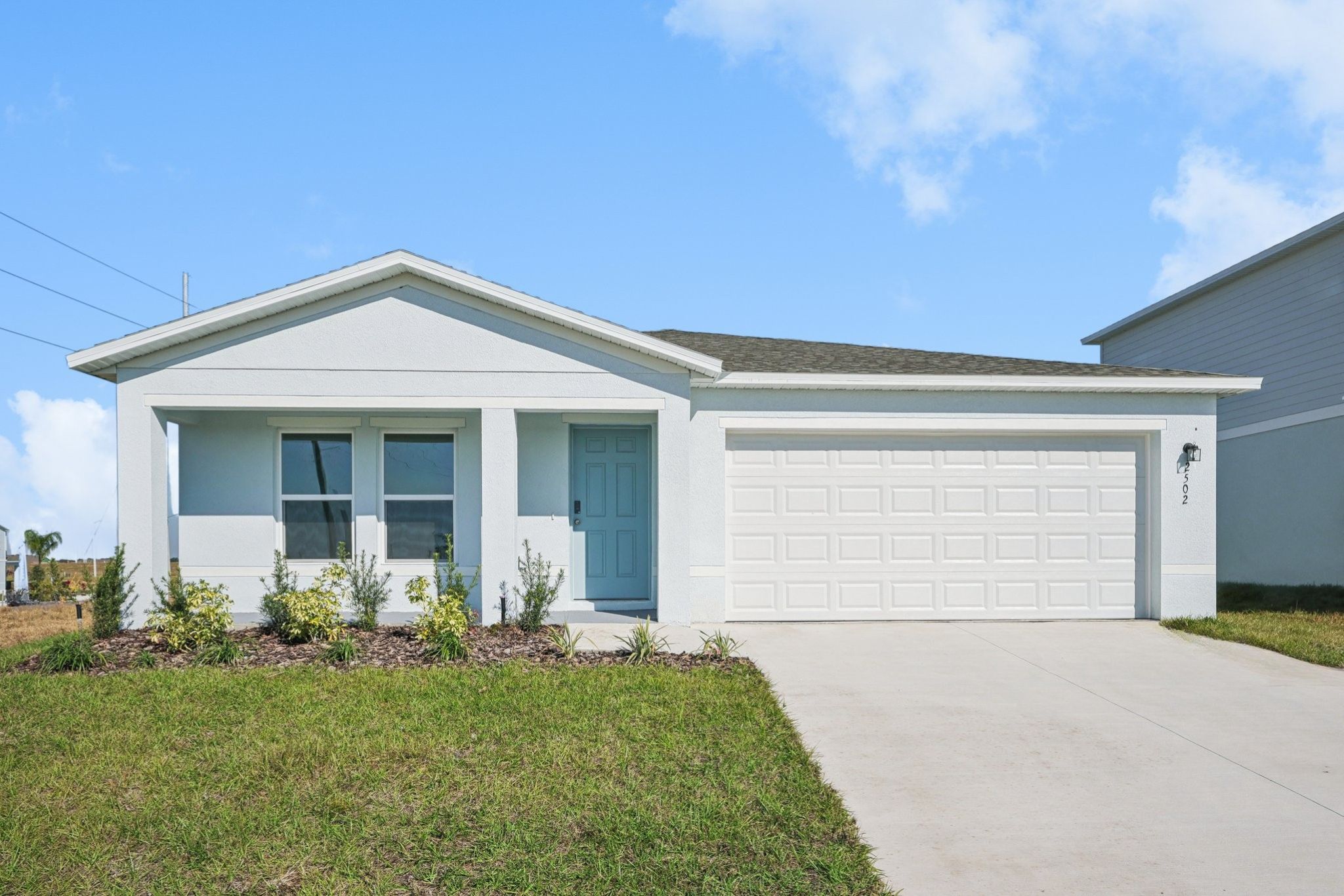 A white house with a garage.