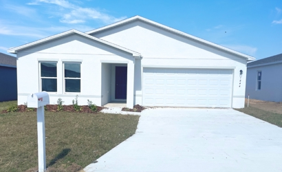 A white house with a garage.