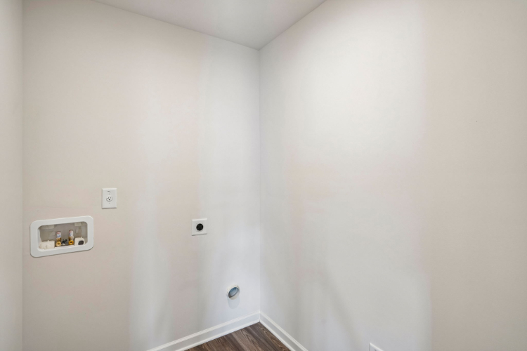 A white wall with a switch.