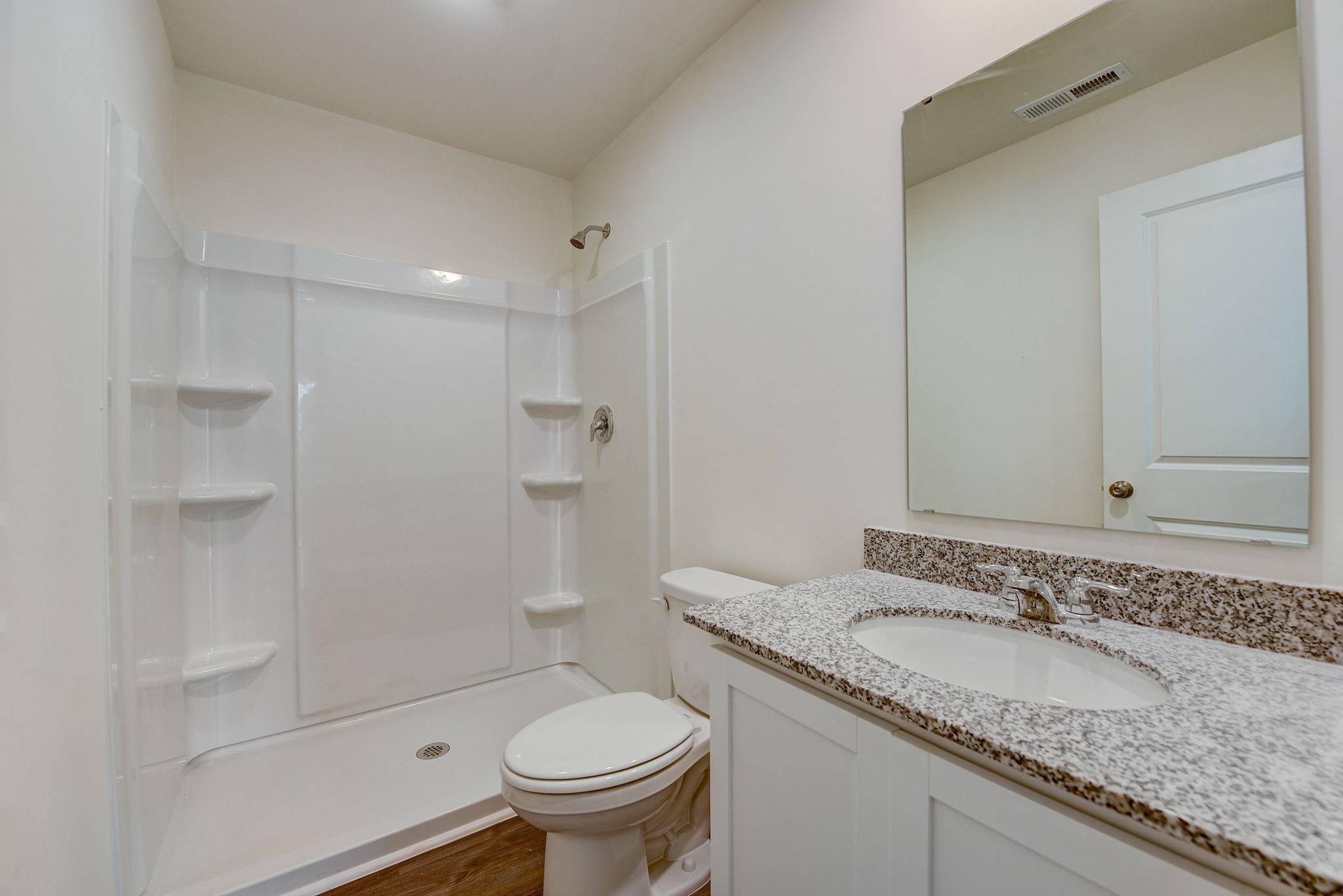 A bathroom with a sink and a shower.