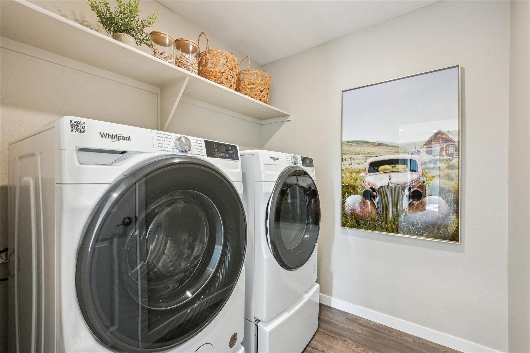 A washing machine and dryer in a room.